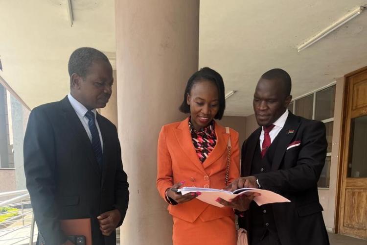 from (L) TO R: Phaula, Chilima and the AG discussing the case outside the court